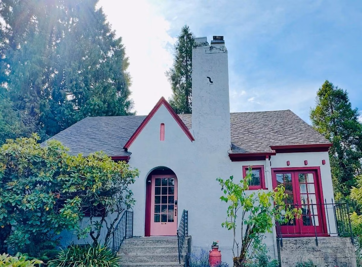 Cottage in Roseburg after painting, with raspberry trim and a pink door