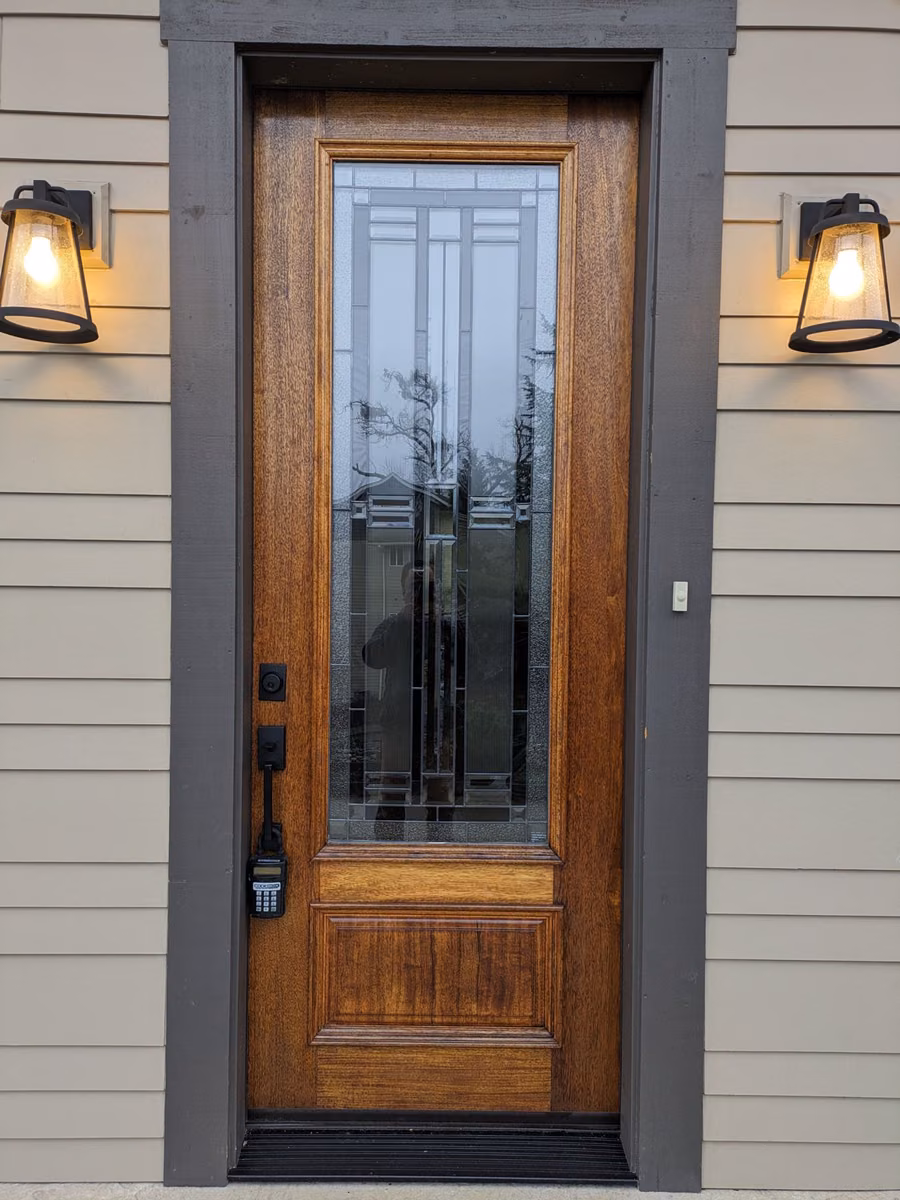 Wood front door after refinishing, with a deep glossy finish